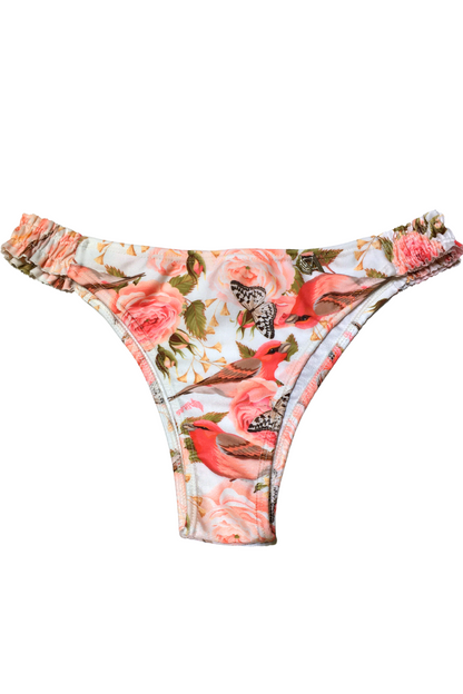 Bombacha de bikini Vedetina Alita con frunce lateral y estampado exclusivo de aves y rosas sobre fondo crema.